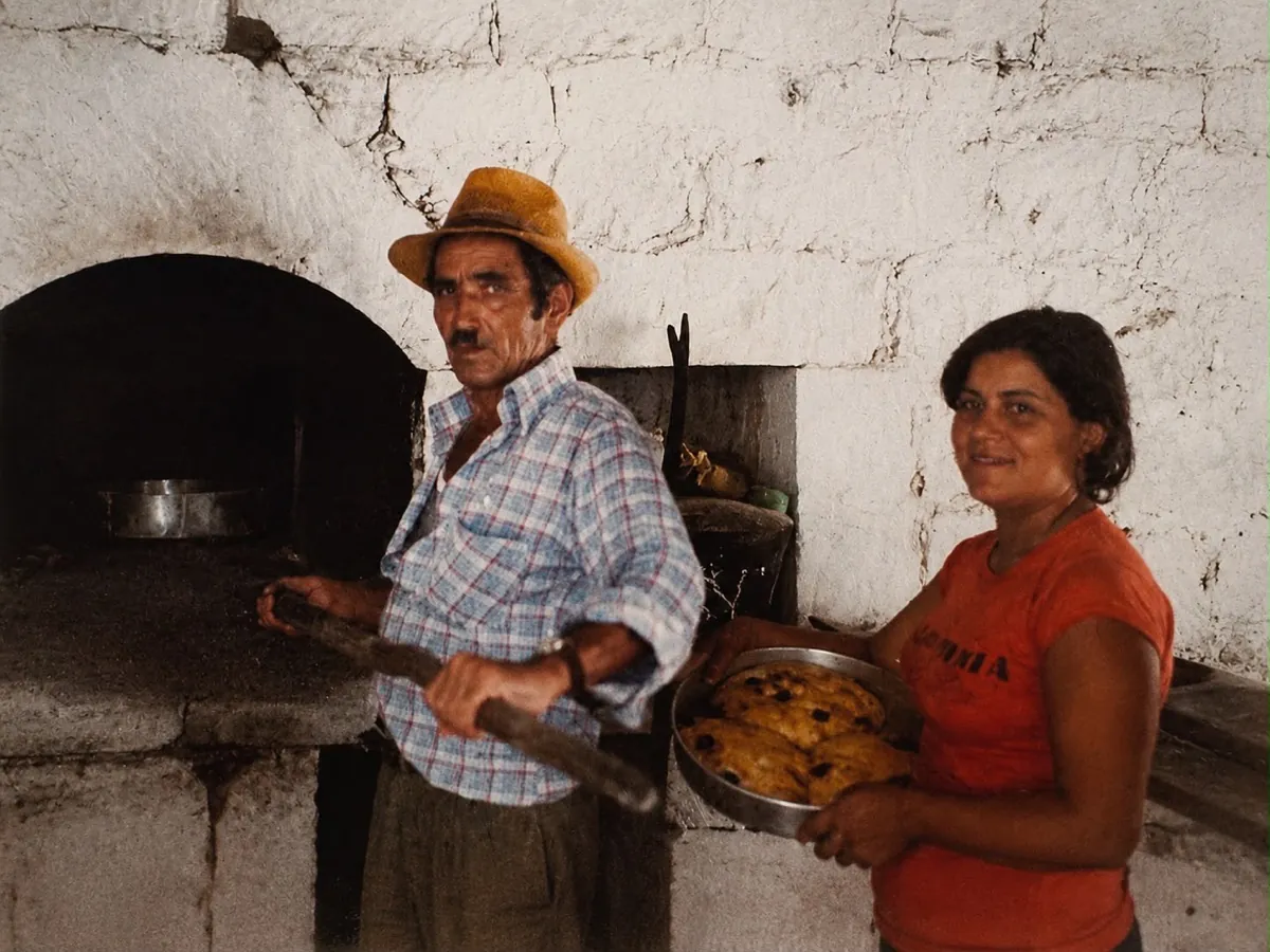 Family baking at the traditional village fourno